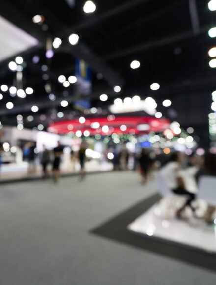 Blurred, defocused background of public event exhibition hall. Business trade show or commercial activity concept Blurred, defocused background of public event exhibition hall. Business trade show or commercial activity concept